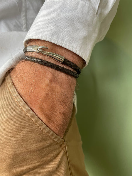 Silver tusk and leather bracelet.